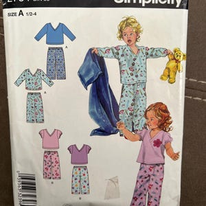 May include: Simplicity sewing pattern for children's pajamas, size A 1/2-4. The pattern includes illustrations of pajama sets in blue and pink, with various prints. The packaging features the text "IT'S SO easy".