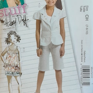 May include: A sewing pattern for a white blazer and shorts outfit for children. The pattern is from McCall's and is designed by Hilary Duff. The pattern number is M5376 and the size is CH (7-8-10).
