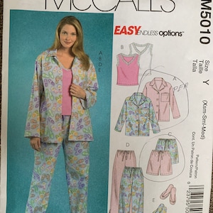 May include: A sewing pattern for pajamas with a blue and pink floral print. The pattern includes a shirt, pants, shorts, and slippers. The pattern is called "Easy Endless Options" and is from McCall's. The pattern number is M5010.