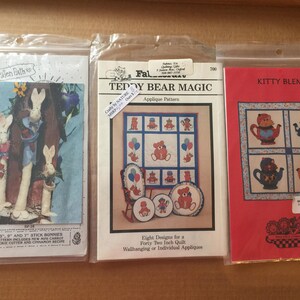 May include: Three craft patterns for applique projects. The first pattern is for a set of 13, 9, and 7 inch stick bunnies. The second pattern is for a teddy bear magic quilt with eight designs for a 42 inch quilt. The third pattern is for a kitty blend quilt.
