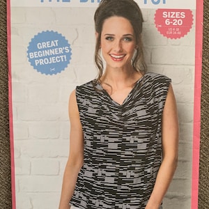 May include: A sewing pattern titled "The Drape Top" featuring a woman wearing a black and white patterned top. The pattern includes sizes 6-20 (US 4-18, EUR 34-48) and is labeled as a "Great Beginner's Project!"