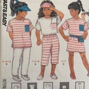 May include: A sewing pattern for a striped top, dress, shorts, and pants. The pattern includes instructions for sizes 2-6, 1-5, and 3-7. The pattern is called "Fast & Easy".