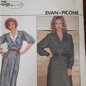 May include: A vintage sewing pattern for a dress by Evan-Picone. The pattern is for sizes 10-12 and is pre-cut. The pattern features a woman wearing a striped dress with a belt.