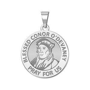 May include: Silver pendant featuring a portrait of Blessed Conor O'Devany with the inscription "Blessed Conor O'Devany Pray For Us".