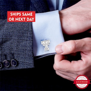 May include: Silver cufflinks featuring a white Texas Tech University logo on a blue background. The cufflinks are worn on a white dress shirt with a blue cuff. The text "SHIPS SAME OR NEXT DAY" is in red on a white background. The text "OFFICIALLY LICENSED PRODUCT" is in red on a white background with a red star.