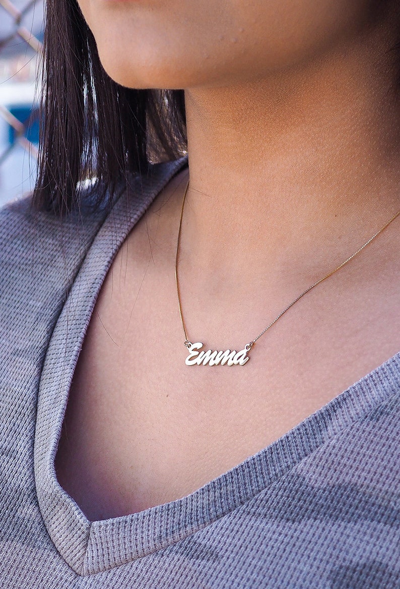 Emma name necklace in silver on a females neck