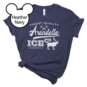 May include: Heather navy blue t-shirt with a white graphic design that says "Finest Quality Arendelle Ice Co. Since 2013". The graphic includes a pair of crossed pickaxes and a white silhouette of a reindeer.