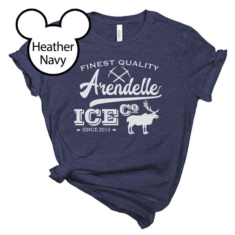 May include: Heather navy blue t-shirt with a white graphic design that says "Finest Quality Arendelle Ice Co. Since 2013". The graphic includes a pair of crossed pickaxes and a white silhouette of a reindeer.