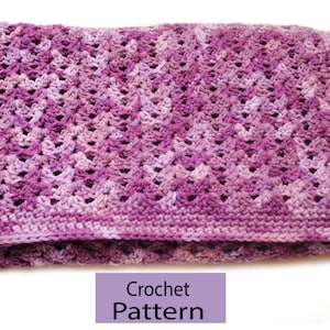 May include: A purple crochet blanket with a lacy pattern. Crochet Pattern.