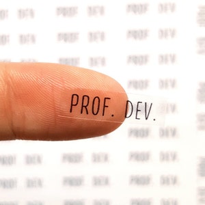 May include: A clear sticker with the text "PROF. DEV." printed in black.