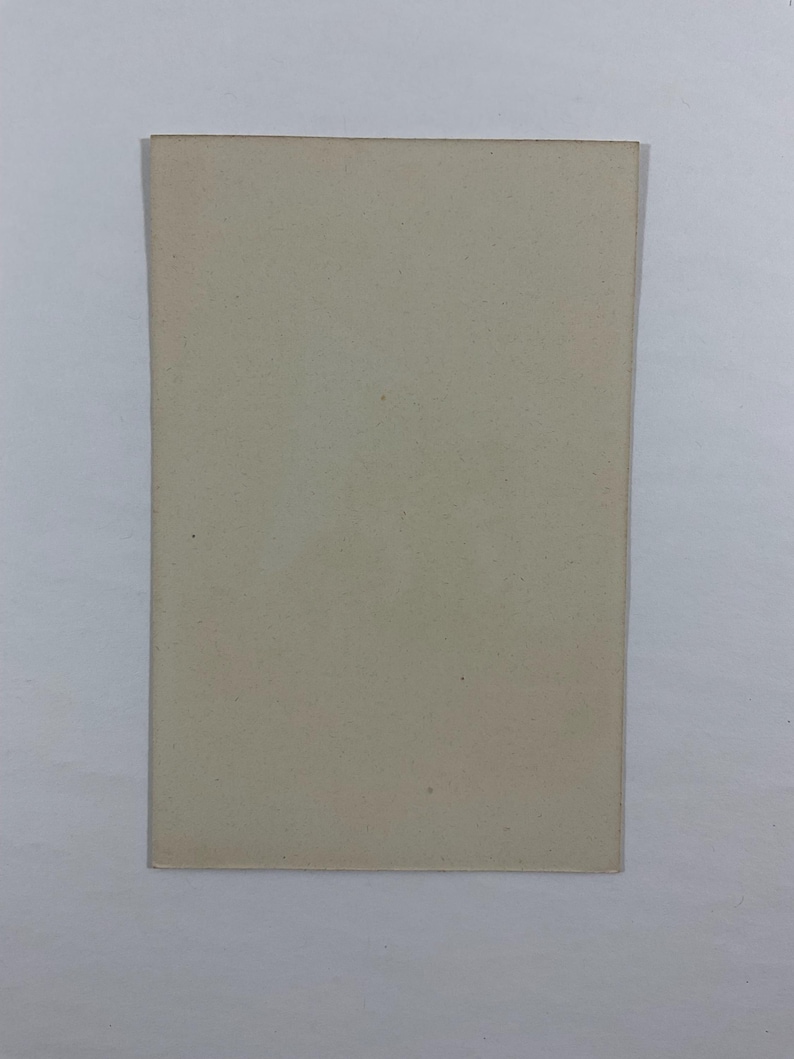 May include: A rectangular, off-white card with a slightly textured surface. The card has a simple, minimalist design, with a solid color and clean edges. The card is likely used for notes or as a blank canvas.