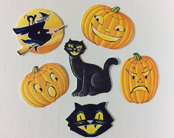 May include: Six Halloween-themed paper cutouts: a witch flying on a broomstick, a black cat, a pumpkin with a happy face, a pumpkin with a sad face, a pumpkin with a surprised face, and a black cat with a scary face.