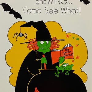 May include: A greeting card illustration featuring a green-skinned witch in a black robe and hat stirring a black cauldron over orange flames. A green frog sits on the cauldron rim, a spider hangs from the hat, and the text reads SOMETHING'S BREWING... Come See What! and the goblin gourmet.