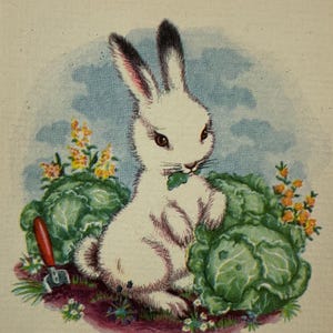 May include: A vintage illustration of a white rabbit with black-tipped ears, sitting among green cabbages and yellow flowers. The rabbit is eating a leaf. A small red and silver gardening tool is in the foreground.