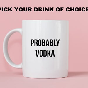 May include: White ceramic mug with a black inscription that reads "PROBABLY VODKA" against a pink background.