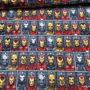 May include: A repeating pattern of Iron Man's face in various poses, with a gray background and a red, yellow, and black color scheme.