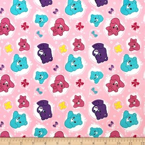 May include: Pink fabric with a repeating pattern of Care Bears in white circles. The bears are wearing different colored bows and have different colored eyes. The background is a light pink.