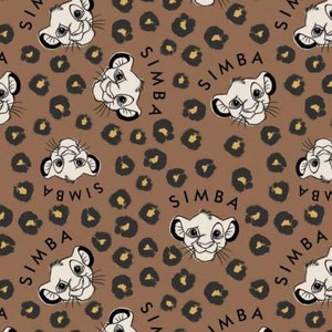 May include: A brown fabric with a repeating pattern of a cartoon lion cub with the word "SIMBA" printed on it. The lion cub is surrounded by brown leopard spots.