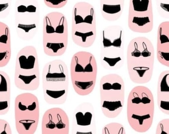 May include: A pattern of black lingerie on a pink background. The image features a variety of styles, including bras, panties, and bralettes.