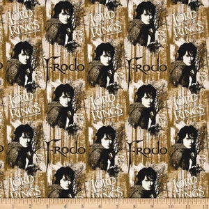 May include: A brown and black fabric with a repeating pattern of Frodo Baggins from the Lord of the Rings movie. The pattern includes the words "The Lord of the Rings" and "Frodo" repeated throughout the fabric.