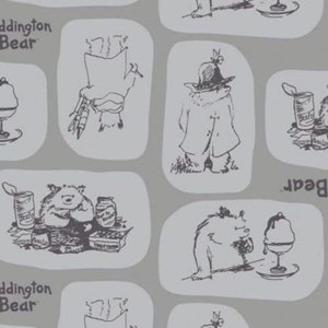 May include: A gray and white patterned fabric with illustrations of Paddington Bear in various scenes. The fabric features Paddington Bear eating ice cream, holding a can of beans, and wearing a coat. The text "Paddington Bear" is repeated throughout the fabric.