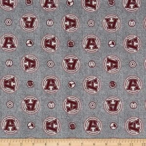 May include: A gray and white fabric with a repeating pattern of red circles. The circles contain the text "Earth's Mightiest Heroes" and "Avengers" with a large "A" in the center. The fabric has a denim-like texture.