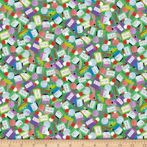 May include: A green fabric with a repeating pattern of various craft supplies, including pom-poms, beads, buttons, glitter, and yarn. The words "glitter", "pompoms", "beads", "buttons", and "snowflake" are repeated throughout the pattern.