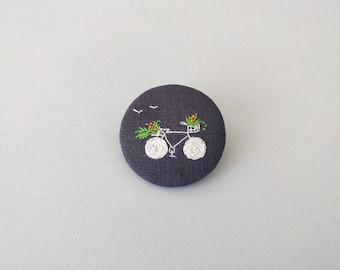 Bike brooch and flower basket (dark grey background), hand-embroidered linen brooch, textile brooch with embroidery