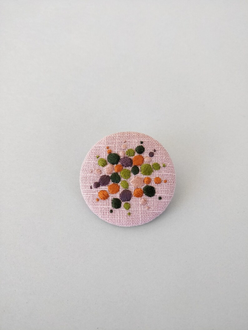 Brooch with embroidery style colored pearls on pink background image 6
