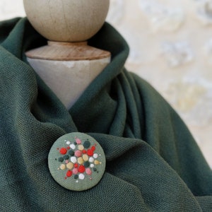 Brooch with embroidery style colored pearls on a light green background image 8