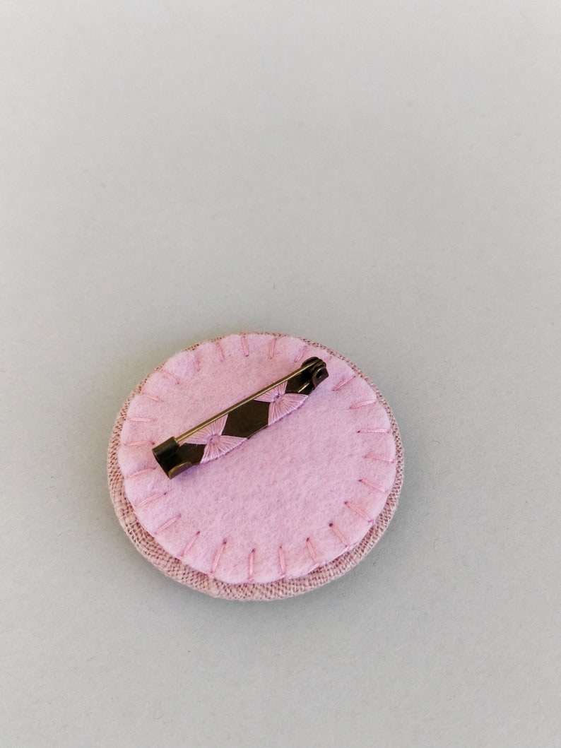 Brooch with embroidery style colored pearls on pink background image 7