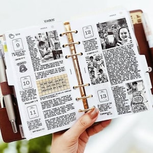 Puede incluir: Un planificador de cuero marrón con detalles dorados, abierto en una página con notas manuscritas, fechas y pequeñas fotos en blanco y negro. Un bolígrafo plateado descansa en el lomo del planificador. El planificador está en manos de una persona.