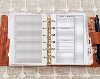 May include: A brown leather six-ring binder planner open to a weekly layout. The left page features a grid for Monday through Sunday. The right page includes sections for dailies, weekly tasks, and a food log. Tabbed dividers label months and categories.