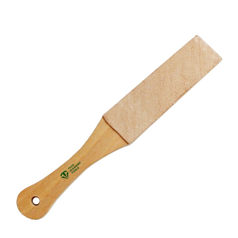 May include: A wooden strop with a light brown leather surface. The handle is made of light-colored wood and features the text "TECH DIAMOND TOOLS" in green. A hole is drilled at the end of the handle.