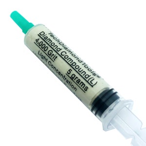 May include: A syringe containing TechDiamondTools Diamond Compound (L). The label indicates 4,000 Grit and 5 grams of light concentration. The syringe has a clear body, black plunger, and a green tip.