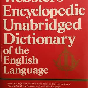 May include: A red hardcover book titled Webster's Encyclopedic Unabridged Dictionary of the English Language. The cover features cream-colored text and a gold emblem. It includes details about quarter million entries, illustrations, and a world atlas.