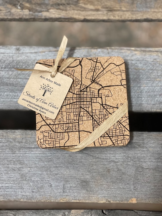 Four cork coasters engraved with an Ann Arbor street map