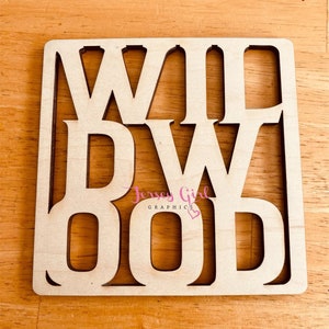 May include: Wooden sign with the words "WILDWOOD" cut out in a square shape. The sign is light brown and has a slightly distressed look. The words are in a bold, blocky font.