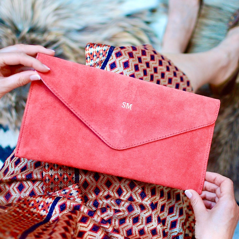 Monogrammed Suede Envelope Clutch - Coral with gold foil initials shown close up with model.