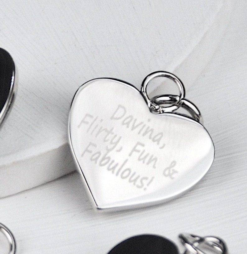 Rhodium plated heart shaped disc charm which can be engraved on one or both sides shown close up.