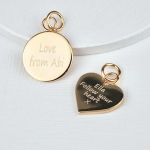 Personalised Gold Heart or Circle Disc Charm which is engraved on one or both sides. Shown close up with jump ring.