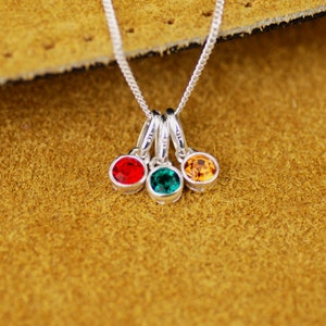 Sterling Silver Family Birthstone Necklace close-up with Ruby/July, Emerald/May and Citrine/November birthstone charms.