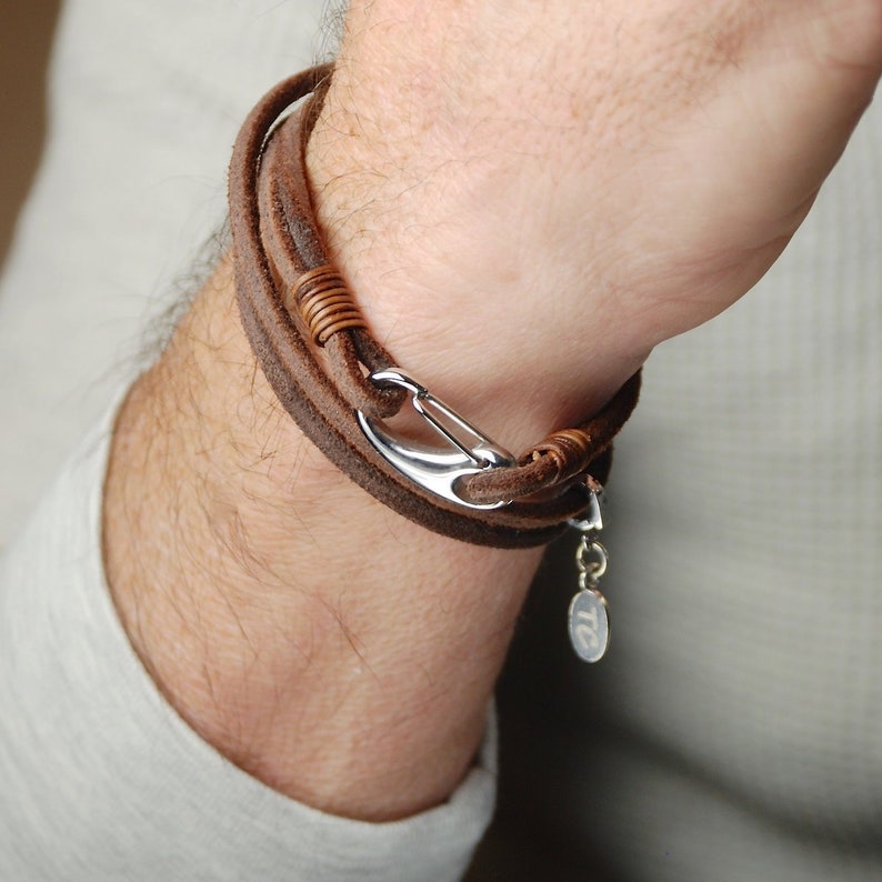 Personalised Men's suede double wrap bracelet shown in brown suede with engraved disc shown close up on model.