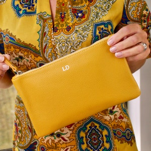 Monogram Leather Cosmetic Bag in mustard showing LD initials in silver close up with model.