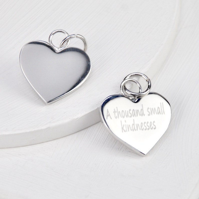 Rhodium plated heart shaped disc charm which can be engraved on one or both sides shown close up.