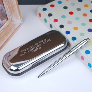 Engraved Pen and Box Set with text engraved in straight walk font style shown close up on a desk