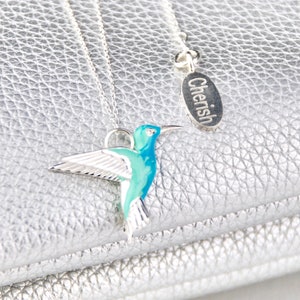 Sterling Silver and Enamel Hummingbird Necklace shown in close up with engraved oval message disc