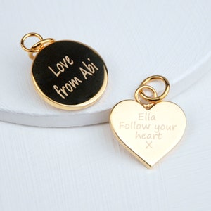 Personalised Gold Heart or Circle Disc Charm which is engraved on one or both sides. Shown close up with jump ring.