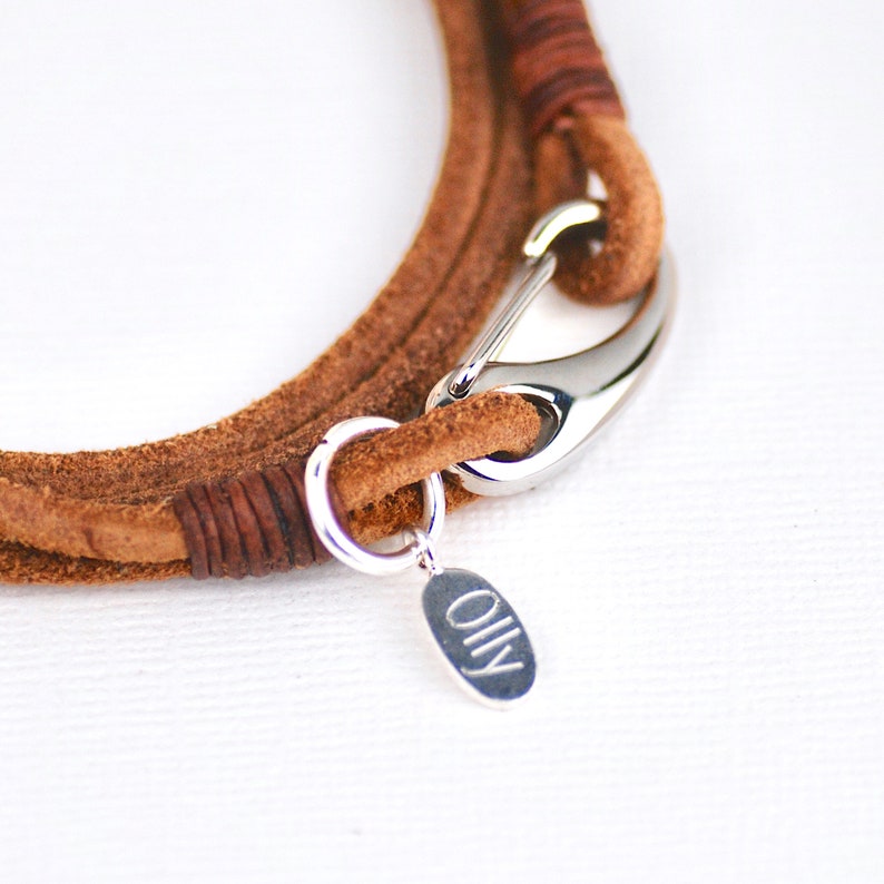 Close up details of suede double wrap bracelet with engraved disc.