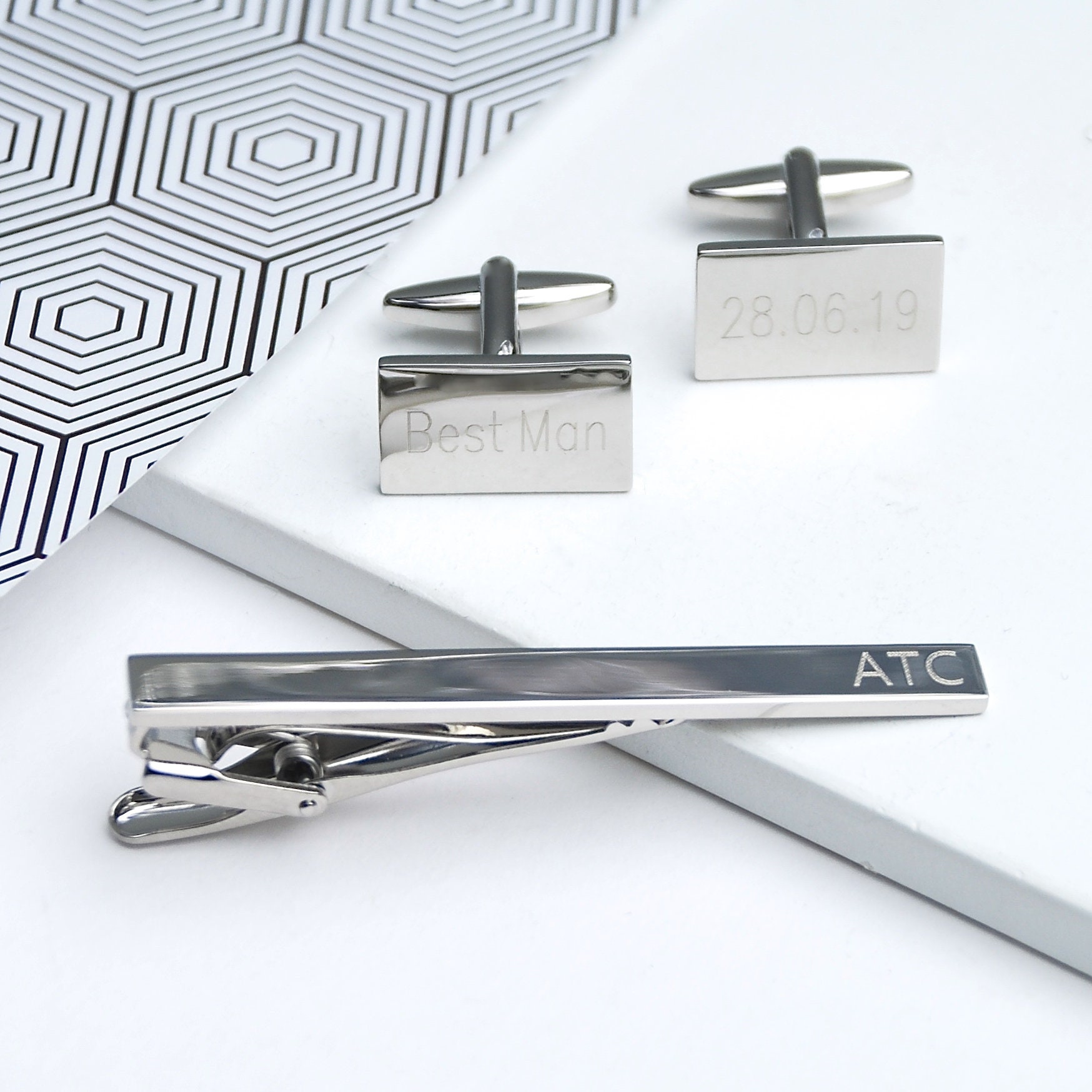 Silver tie bar and cufflink set with logo